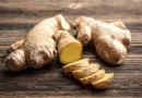 Fresh ginger root with sliced ginger in a kitchen setting for an article about ginger benefits and safe daily use