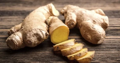 Fresh ginger root with sliced ginger in a kitchen setting for an article about ginger benefits and safe daily use