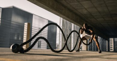 man exercising with large ropes.