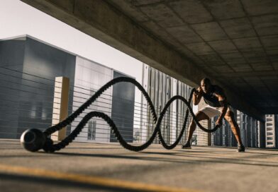 man exercising with large ropes.