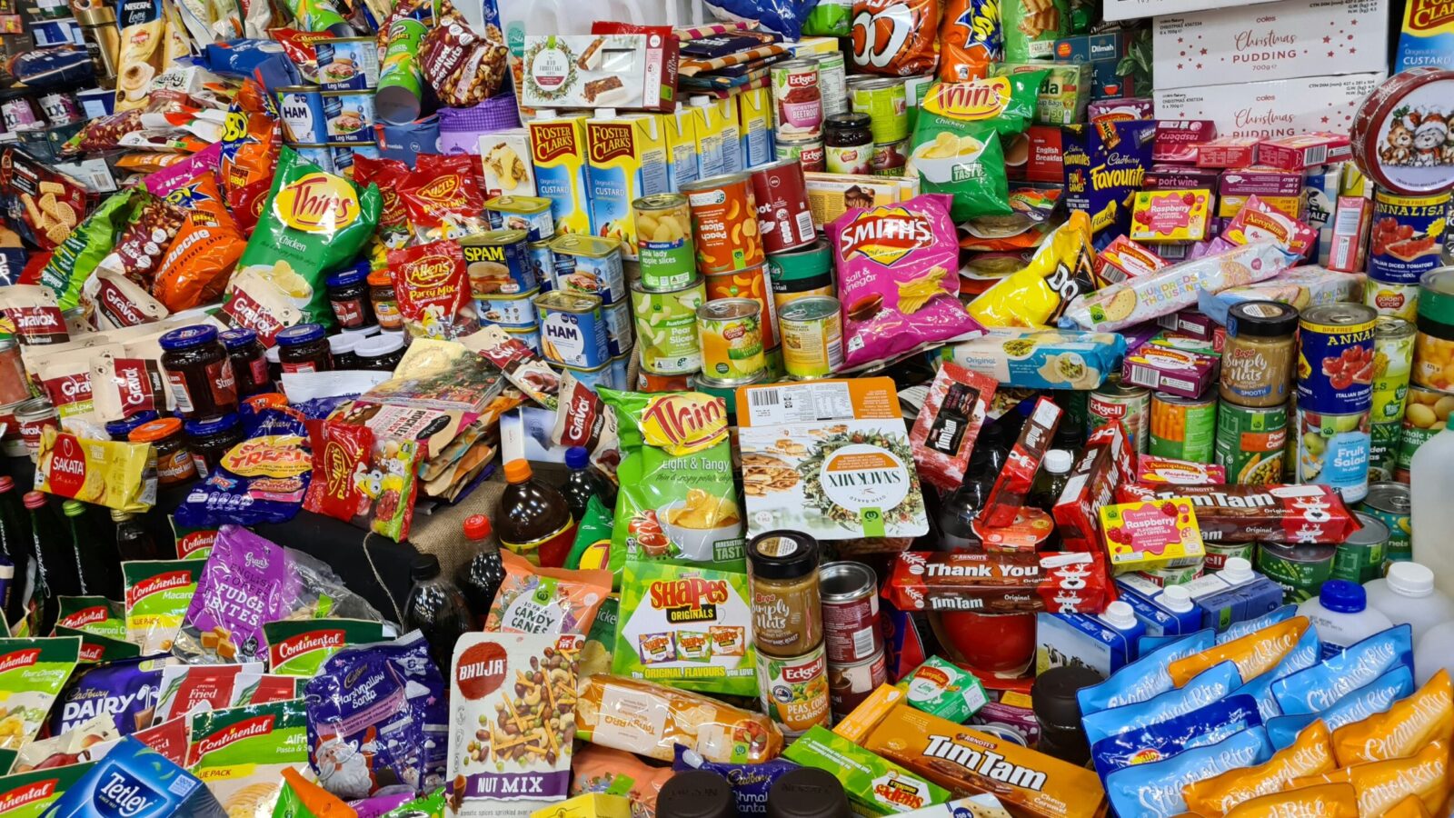 A visual spread of ultra-processed foods including chips, soda, frozen meals, and sweets.